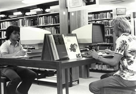 Clients using the microfiche catalogue in the 1980s.