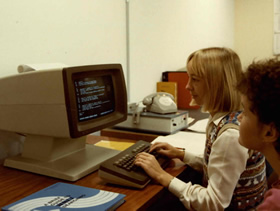A WAIT librarian searching online databases for a client, late 1980s