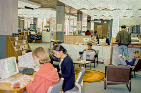 Level three of the Library in the mid 1990s, showing catalogue terminals, comfortable seating areas and the information desk.