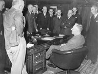 Prime Minister John Curtin chatting with the Canberra Press Gallery, known as ‘the Circus’, c. 1944. JCPML00376/2.