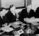 Governor General Lord Gowrie (right) signing the proclamation of a state of war with Japan, watched by Prime Minister Curtin and Deputy Prime Minister, Frank Forde December 1941. JCPML00376/102