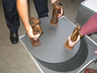 Two people are needed to safely move the figurines on their base in and out of the aluminium crate.