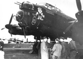 Curtin in front of plane talking with RAAF men, 1944. JCPML00018/33
