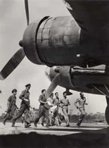 The crew of a United States Flying Fortress running to their stations when the alarm was given for immediate take-off at a base somewhere in Australia, 1942