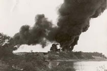 Darwin - Smoke from a burning oil storage tank after a Japanese air raid, 1942