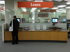 A client borrowing items using one of the self-service terminals on level two, 2007.