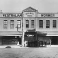 Westralian Worker staff with John Curtin leaning on the verandah post c. 1920. JCPML00379/2.