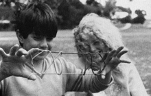 Image of children making string figures.