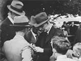 John Curtin signing autographs in Canberra, 1942