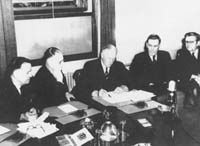 Governor General Lord Gowrie (centre) signing the Declaration of War on Japan
