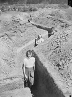 Staff members check the air raid trenches being dug in the grounds of Parliament House, 1942