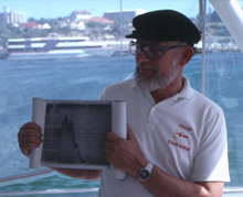 John Penrose showing sounder charts to Project Endeavour members, 1987. CUL00039/15/22.