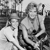 Hazel Hawke and a school girl planting a tree